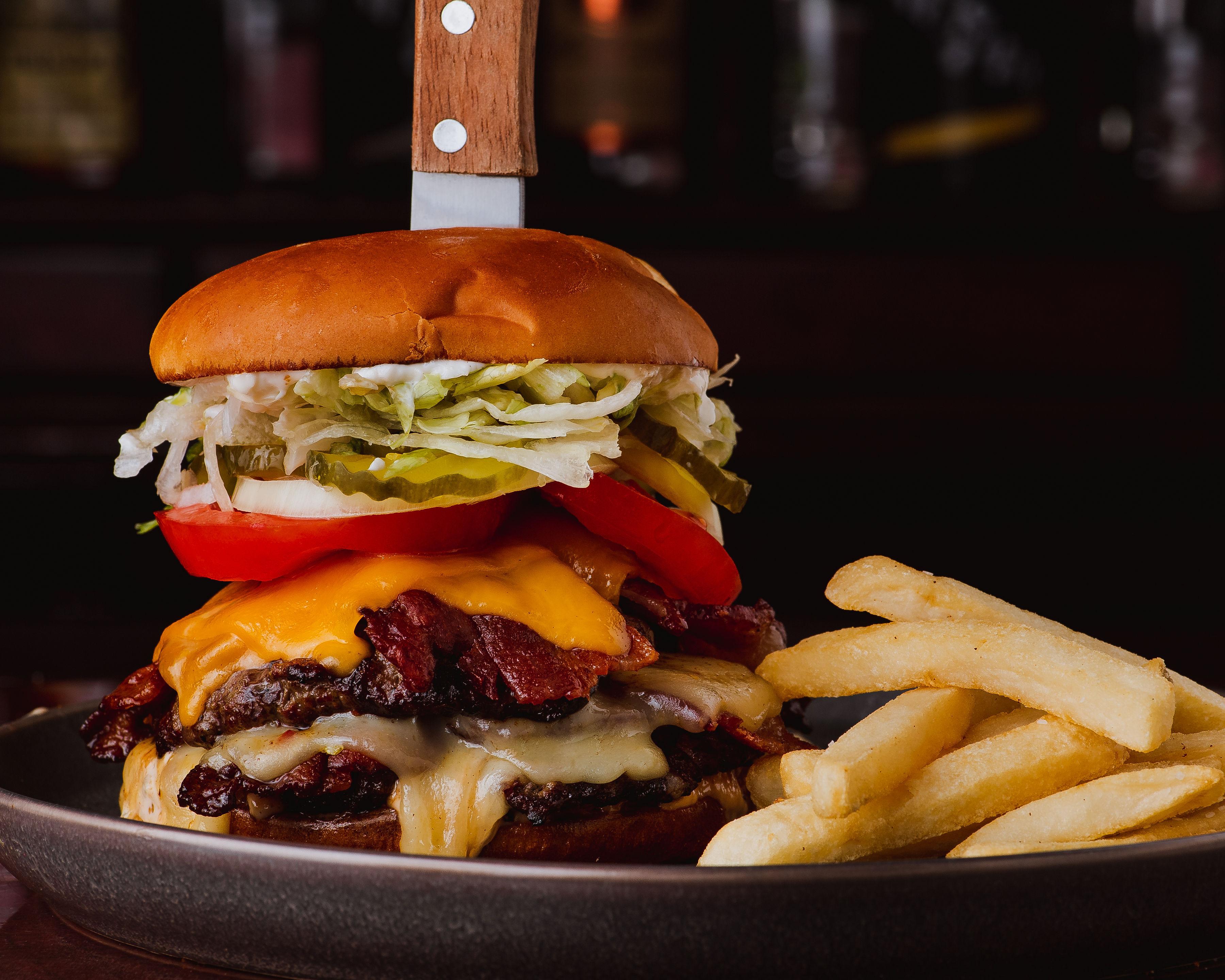 Appetite For Destruction — a full-pound bacon cheeseburger with a knife driven through the bun
